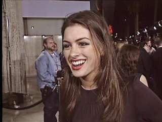 Anne Hathaway in an interview in a transparent blouse and without a bra